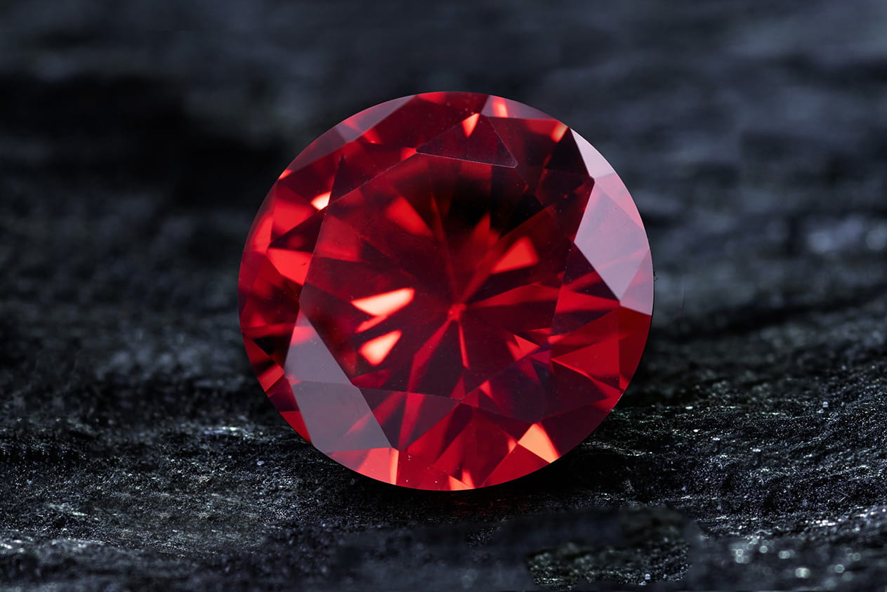 Photo: A gemstone emitting a deep crimson glow