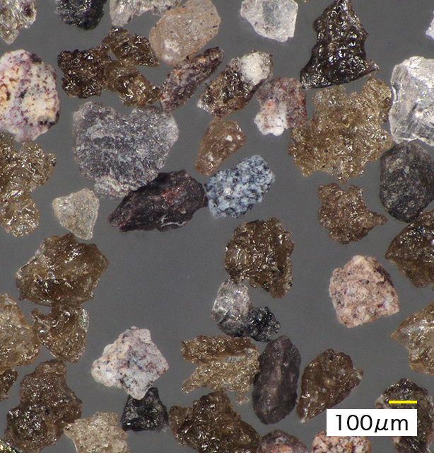 Volcanic Ash Particles Viewed Under a Microscope (*)